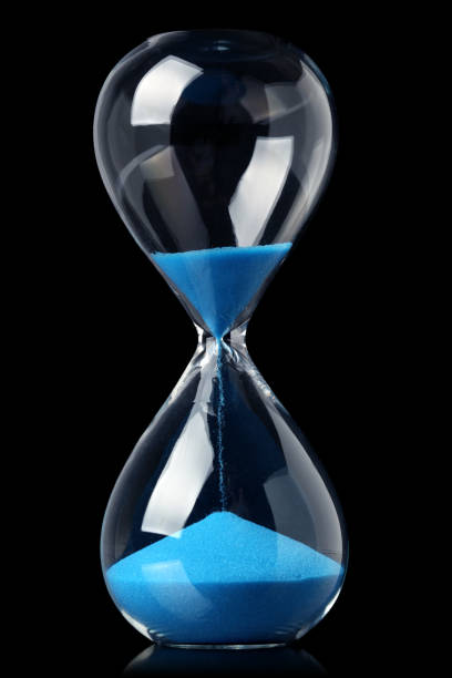 istock Hourglass with blue sand showing the passage of time 1283265577