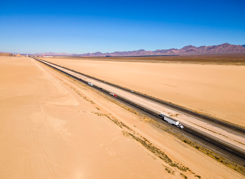 Two lane freeway on sandy desert