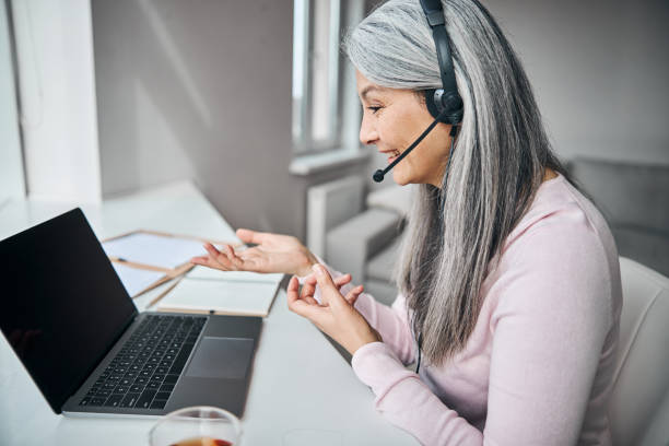 istock Cheerful woman using modern laptop for online communication 1283267802
