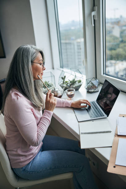istock Beautiful lady working on notebook at home 1283267902