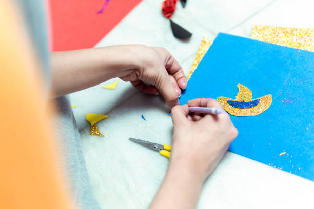 istock Female hands making craft with paper. cutting paper with scissors. 1283268592