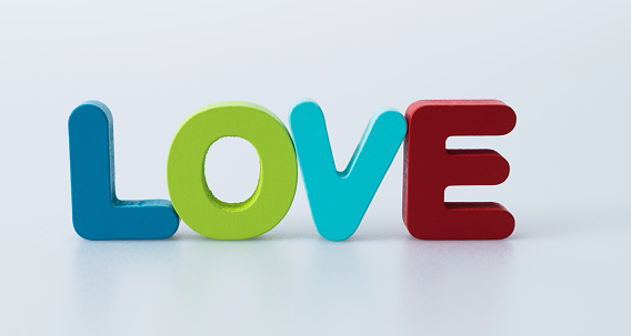 Wooden word love on white background.