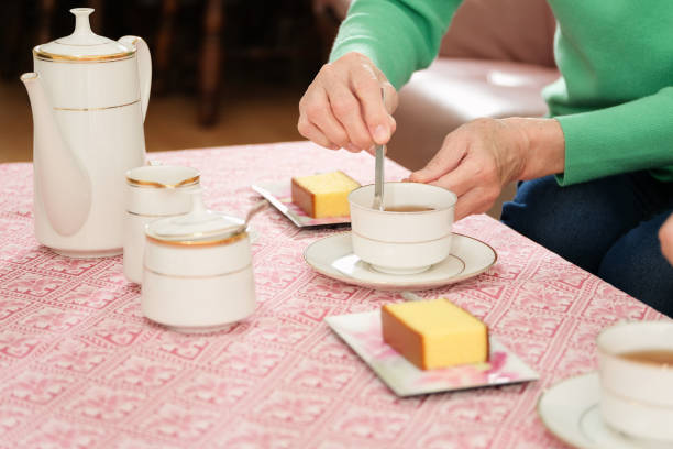 istock Closeup of woman’s hands adding sugar to tea 1283276657