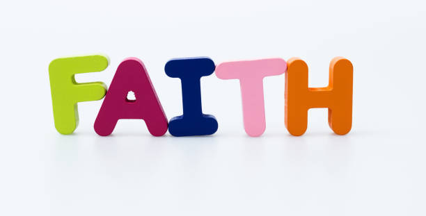 istock Wooden word faith on white background 1283277574