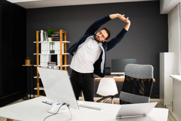 istock Exercise Stretch Standing Near Office Desk 1283277747