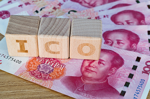 Wooden word ICO on Chinese yuan.