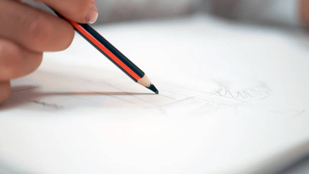 istock Girl with white nails draws a sketch on paper 1283280010
