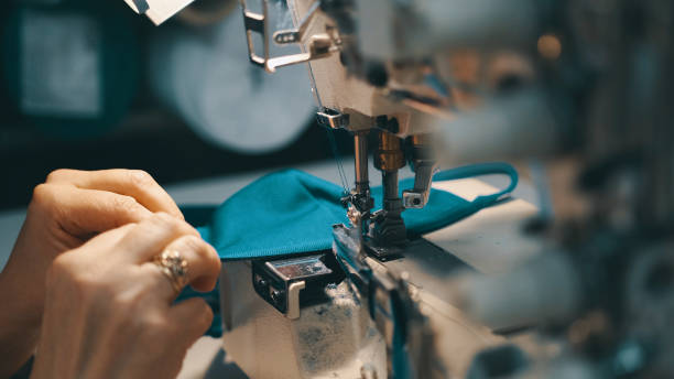 istock Woman seamstress works at a sewing machine 1283280036