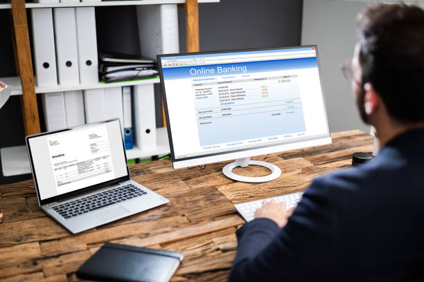 istock Young Businessman Looking At Invoice While Doing Online Banking 1283280211
