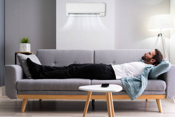 istock Happy Man Relaxing And Enjoying Cool Air Conditioner 1283281321