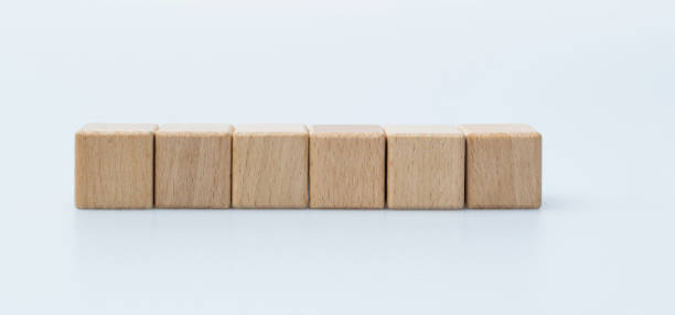 istock Six wooden blocks in a row on white background 1283282266