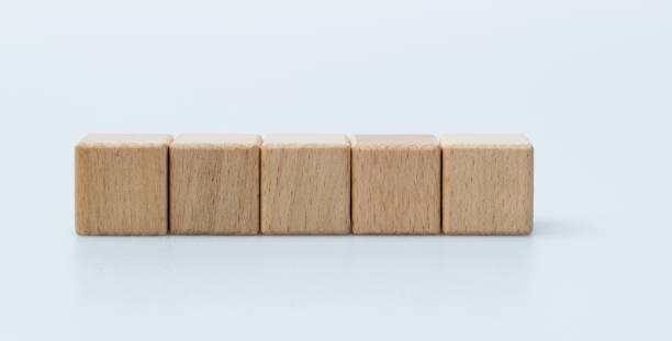 istock Five wooden blocks in a row on white background 1283282270