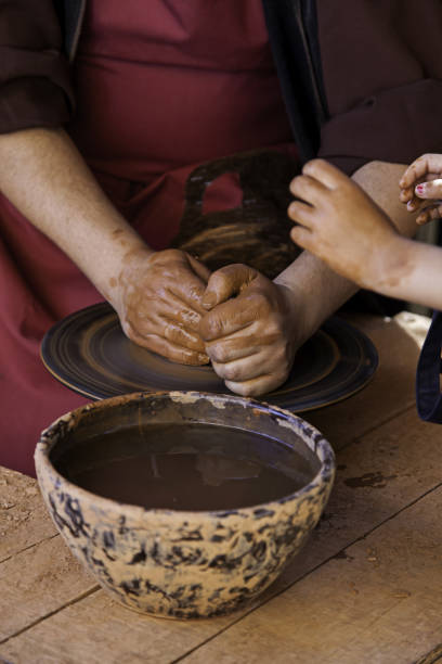 istock Hands of a potter forming clay 1283282957