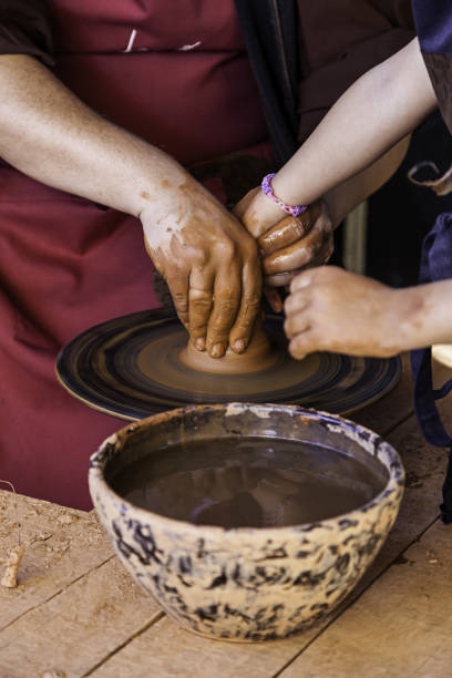 istock Hands of a potter forming clay 1283282959