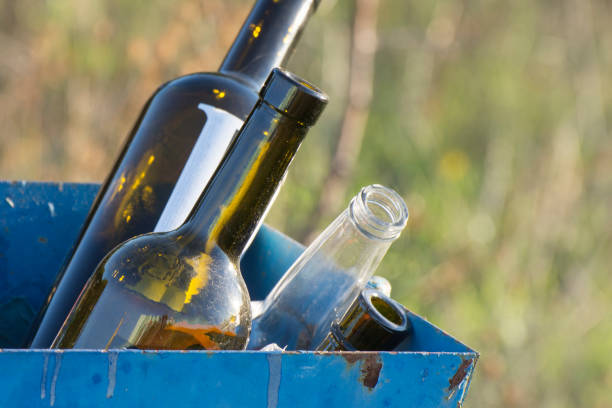 istock The empty alcohol bottles in the trash can. Simple background discarded wine bottles. Garbage removal and glass container recycling. 1283286321