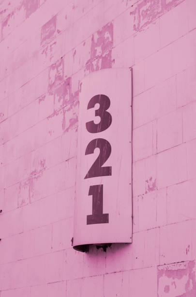 Semicircular sign on the wall with numbers 3,2,1.