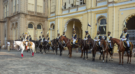 A beautiful view of the Horsemen and their Horses belonging to the Royal Palace seen participating in \nthe Dasara Parade in front of the Iconic Heritage Palace in Mysore/India.