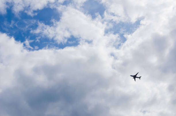 istock Airplane flying against clouds in the sky 1283289023