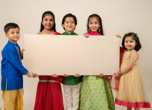 Group of children holding white board in studio
