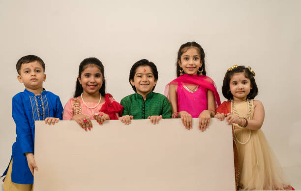 istock Group of children holding white board in studio 1283289128