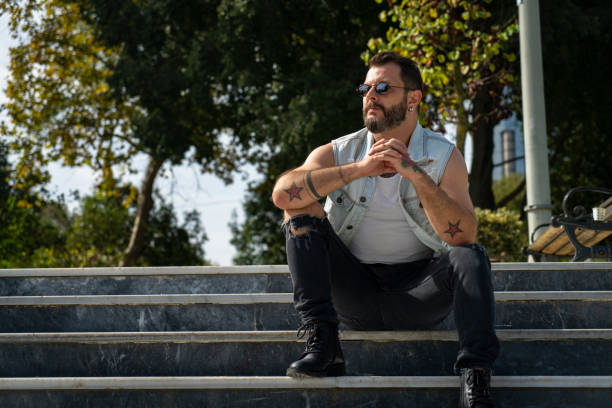 istock Man sits on the stairs in the park 1283290851
