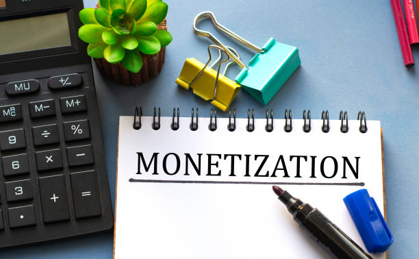 istock MONETIZATION word is written in a notebook with a marker, calculator, clamps and cactus 1283292959