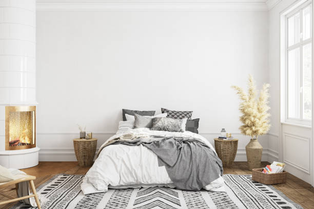 istock White bedroom interior with fireplace carpet, dry plants and decor. 3d render illustration mock up. 1283296415