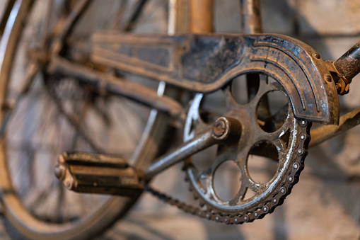 Closeup view of flat wheel of bicycle which parked beside the garden, soft and selective focus.