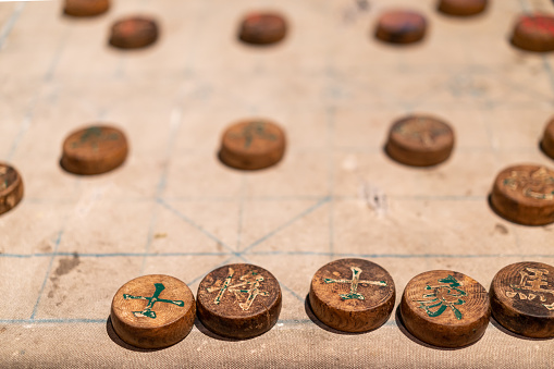 In a social gathering held for active seniors, a small group is playing ludo game and enjoying the time together.