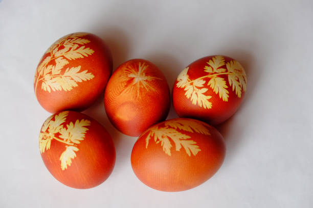 istock Painted Easter eggs on a white background. Floral pattern on a red eggshell. Festive food. 1283298299