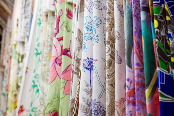 istock Multi-colored fabrics in the store close-up hanging 1283298593