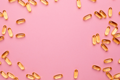 Vitamins Omega 3 6 9 fish oil , vitamin D on a pink background for health lifestyle with copyspace top view