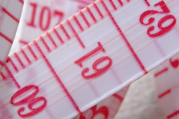 istock Tailor measuring tape with red numbers. 1283299589