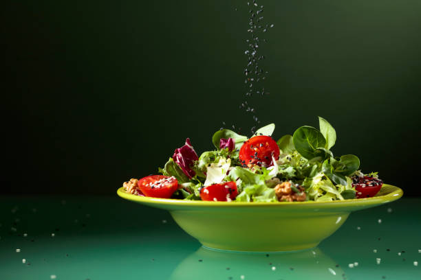 istock Green salad with cherry tomatoes, walnuts and sesame. 1283299720