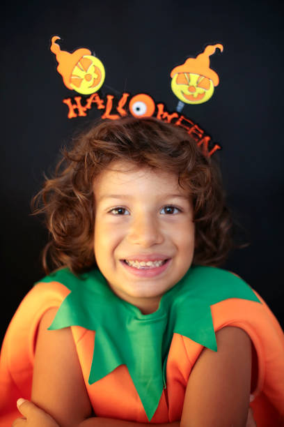 istock Cute kid in halloween costume scaring pose. 1283300565