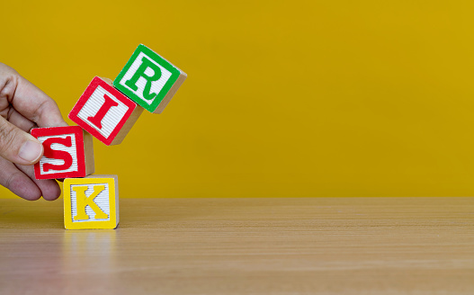 Wooden cubes with word risk.