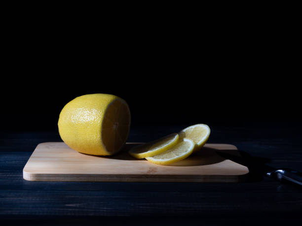 istock A lemon on a cutting board in the dark. 1283302252