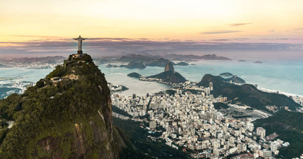 Christ the Redeemer statue in Rio de Janeiro (aerial shot) during a spectacular sunset Cristo Redentor statue in Rio de Janeiro (aerial shot made from a helicopter) during a spectacular sunset cristo redentor rio de janeiro stock pictures, royalty-free photos & images