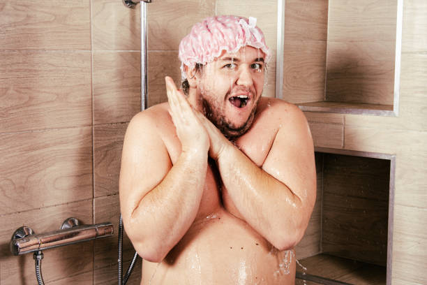 istock Funny fat guy in the shower. 1283303053