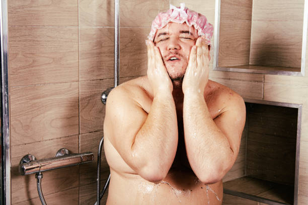 istock Funny fat guy in the shower. 1283303082