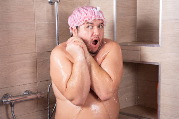 istock Funny fat guy in the shower. 1283303217