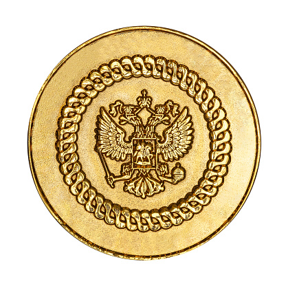 Russian coat of arms on the gold medal, isolated on a white background