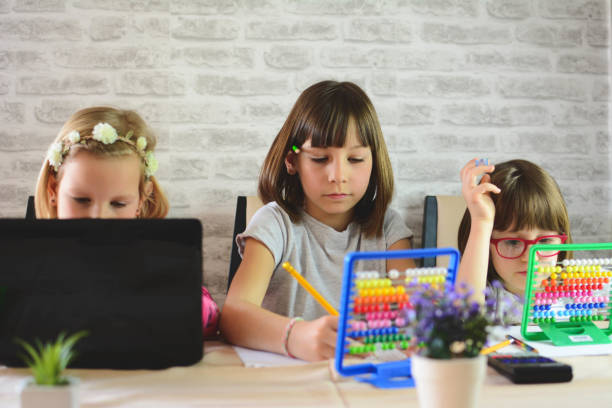istock Homeschooling - Daughters To Finish School Homework During Coronavirus Quarantine 1283304463