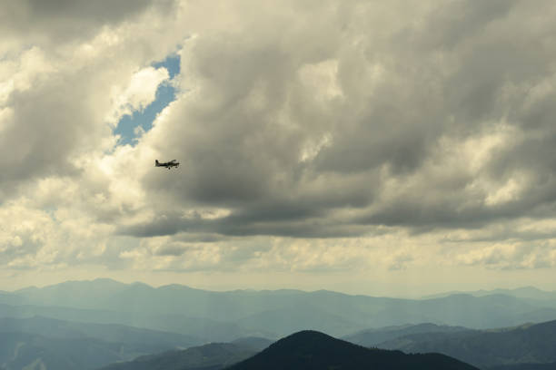 istock Airplane among clouds in mountains. Transport. Aircraft 1283307612