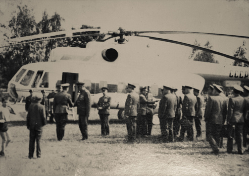 East Berlin, German Democratic Republic, 1970. group of Soviet soldiers in full dress in front of a transport helicopter at a helipad in East Germany