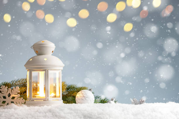 istock White lantern with christmas decorations in a snowdrift on blue background 1283310000