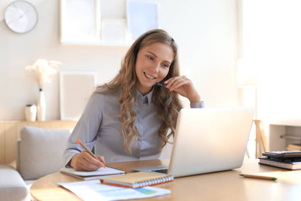 istock Freelance business women using tablet working call video conference with customer in workplace at home. 1283312014
