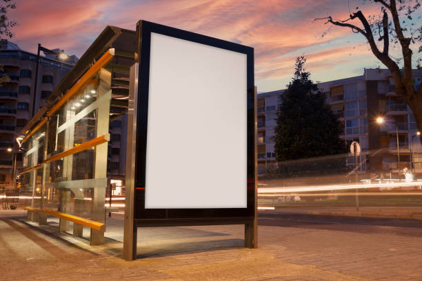 Blank advertisement in a bus stop Blank advertisement in a bus stop, with blurred traffic lights billboard stock pictures, royalty-free photos & images