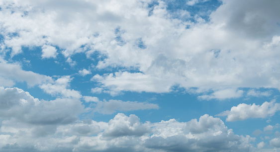 Large cumulus clouds in the blue sky.