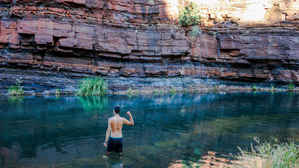 Hiking and swimming in Karijini National-Park, Western Australia with beautiful rock formations stock photo